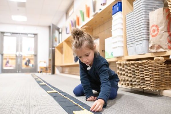 Student learning Montessori Math with the Bead Chain