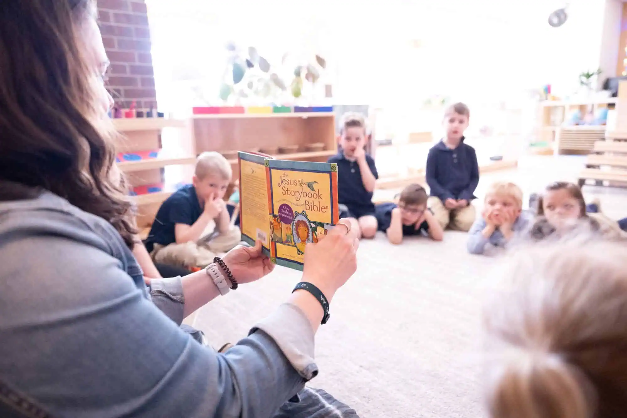 Preschoolers and Kindergarteners reading the Bible and growing their faith at Hand In Hand Christian Montessori